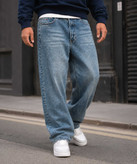 شلوار جین نیم بگ مردانه Tommy آبی کثیف شور در استایل Street Style
